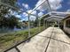 Lake view from wide screened patio with ample room for outdoor seating and dining at 8312 Split Rail Ln, Hudson, FL 34667