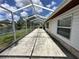 Wide screened patio with a lake view, ideal for outdoor entertaining and relaxation at 8312 Split Rail Ln, Hudson, FL 34667