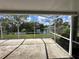 Screened patio overlooking a tranquil lake, offering a serene outdoor space at 8312 Split Rail Ln, Hudson, FL 34667