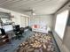 Bright sun room with white walls, desk, seating, and leafy rug creating a relaxed atmosphere at 8312 Split Rail Ln, Hudson, FL 34667