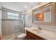 Well-lit bathroom features tiled walk-in shower and classic vanity at 8404 Fishhawk Ave, New Port Richey, FL 34653