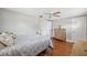 Comfortable bedroom with hardwood floors, ceiling fan and ensuite bathroom access at 8404 Fishhawk Ave, New Port Richey, FL 34653