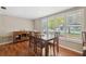 Elegant dining room boasting hardwood floors, a classic wood table, and abundant natural light at 8404 Fishhawk Ave, New Port Richey, FL 34653