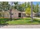 Inviting single-story home with a lush green lawn, mature trees, and charming screened in porch at 8404 Fishhawk Ave, New Port Richey, FL 34653
