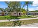 Lovely single-story home with a well-kept lawn, mature trees, and traditional facade at 8404 Fishhawk Ave, New Port Richey, FL 34653