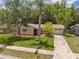 Charming single-story home with a well-manicured lawn, beautiful landscaping, and a cozy screened entrance at 8404 Fishhawk Ave, New Port Richey, FL 34653