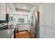 Cozy kitchen boasting stainless steel appliances, white cabinets, and views of the backyard at 8404 Fishhawk Ave, New Port Richey, FL 34653