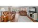 Open-concept living room featuring hardwood floors, a cozy fireplace, and versatile seating at 8404 Fishhawk Ave, New Port Richey, FL 34653