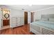 Spacious main bedroom with wood floors, ensuite bathroom, and neutral color scheme at 8404 Fishhawk Ave, New Port Richey, FL 34653