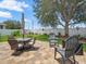 Beautifully landscaped backyard with a patio area, seating, and a well-maintained lawn at 8457 Southern Charm Cir, Brooksville, FL 34613
