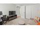 Well-lit bedroom featuring neutral walls, a cozy seating area, and a closet for ample storage at 8457 Southern Charm Cir, Brooksville, FL 34613