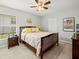 Serene bedroom with a wooden bed frame, neutral colors, and a large window for natural light at 8457 Southern Charm Cir, Brooksville, FL 34613