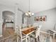 Open dining area flowing into the kitchen and Gathering room, featuring a wooden table and chairs at 8457 Southern Charm Cir, Brooksville, FL 34613
