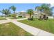 Charming single-story home featuring manicured landscaping, a paver driveway, and lush green lawns at 8457 Southern Charm Cir, Brooksville, FL 34613