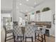 The open kitchen features an island with bar seating and decorative lighting at 8457 Southern Charm Cir, Brooksville, FL 34613