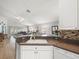 Open-concept kitchen overlooking the living area, featuring a white sink and stylish backsplash at 8457 Southern Charm Cir, Brooksville, FL 34613