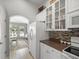 Bright kitchen featuring white cabinets, modern appliances, and an adjacent dining area with sunlit windows at 8457 Southern Charm Cir, Brooksville, FL 34613