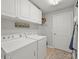 Well-lit laundry room with white cabinets, modern washer and dryer, and functional storage space at 8457 Southern Charm Cir, Brooksville, FL 34613
