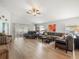 Open living space boasting a vaulted ceiling, neutral paint, wood flooring and ample natural light at 8457 Southern Charm Cir, Brooksville, FL 34613