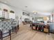 Spacious open-concept living area featuring wood floors, high ceilings, and ample natural light at 8457 Southern Charm Cir, Brooksville, FL 34613