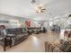 Bright, open-concept living area with wood floors, neutral paint, and seamless kitchen access at 8457 Southern Charm Cir, Brooksville, FL 34613