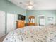 The main bedroom features a ceiling fan, TV, and ensuite bathroom at 8457 Southern Charm Cir, Brooksville, FL 34613