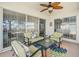 Relaxing screened patio featuring a ceiling fan and ample seating perfect for outdoor enjoyment at 8457 Southern Charm Cir, Brooksville, FL 34613