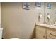 Bright bathroom featuring a sink, vanity, a decorative mirror and marine artwork at 952 Coachlight Ln, Brooksville, FL 34601
