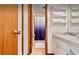 Bright bathroom featuring a sink, vanity, towel rack, and white shower curtain at 952 Coachlight Ln, Brooksville, FL 34601