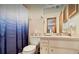 Bright bathroom features a sink, vanity, mirror, and a blue ombre shower curtain at 952 Coachlight Ln, Brooksville, FL 34601