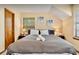 Comfortable bedroom with neutral tones featuring a cozy bed, carpeted floors and two large windows at 952 Coachlight Ln, Brooksville, FL 34601