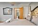 Spacious bedroom features soft decor, carpeted floor and large mirror creating an open, inviting feel at 952 Coachlight Ln, Brooksville, FL 34601