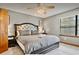 Comfortable bedroom featuring a tufted headboard, soft lighting and neutral colors at 952 Coachlight Ln, Brooksville, FL 34601