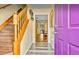 Inviting foyer featuring a wooden staircase and views into the naturally lit living spaces at 952 Coachlight Ln, Brooksville, FL 34601