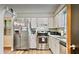 Bright kitchen with stainless steel appliances, ample cabinet space, and modern countertops at 952 Coachlight Ln, Brooksville, FL 34601