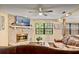 Comfortable living room showcases a stone fireplace, and a ceiling fan, perfect for relaxation at 952 Coachlight Ln, Brooksville, FL 34601