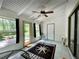 Bright sunroom featuring a ceiling fan, and stylish nautical-themed rug, with views of the outdoor area at 952 Coachlight Ln, Brooksville, FL 34601
