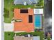 Aerial view of a pool home with solar panels and a terracotta roof in a waterfront community at 9921 San Mateo Way, Port Richey, FL 34668
