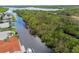 Scenic aerial view showcasing a waterfront property with private dock, and lush greenery at 9921 San Mateo Way, Port Richey, FL 34668