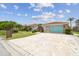 Charming single-story home features a vibrant turquoise garage door and a well-manicured lawn at 9921 San Mateo Way, Port Richey, FL 34668