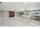 Modern kitchen featuring marble floors, stainless steel appliances, kitchen island and stylish pendant lighting at 9921 San Mateo Way, Port Richey, FL 34668