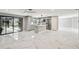 Open kitchen with an island, stainless steel appliances and access to a screened lanai overlooking the pool at 9921 San Mateo Way, Port Richey, FL 34668