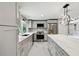 Updated kitchen featuring stainless steel appliances, stone countertops, and a stylish island with pendant lighting at 9921 San Mateo Way, Port Richey, FL 34668