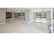 Open-concept living space with marble floors, a fireplace, and a view of the pool and canal at 9921 San Mateo Way, Port Richey, FL 34668