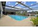 Relaxing screened-in pool with canal view and plenty of room for entertaining outdoors at 9921 San Mateo Way, Port Richey, FL 34668