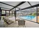Inviting in-ground pool area with screened enclosure, comfortable seating, and scenic waterfront views at 9921 San Mateo Way, Port Richey, FL 34668