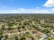Wide aerial view of neighborhood featuring tree-lined streets and a mix of single-Gathering homes and lush greenery at 10091 Bannister St, Spring Hill, FL 34608