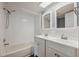 Bathroom with a tub, shower, double sink vanity, and neutral decor at 10091 Bannister St, Spring Hill, FL 34608