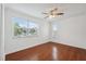 Bright bedroom featuring natural light from the window and hardwood floors at 10091 Bannister St, Spring Hill, FL 34608