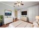 Bedroom with a ceiling fan, two dressers, and a large flat screen TV on the wall at 10091 Bannister St, Spring Hill, FL 34608